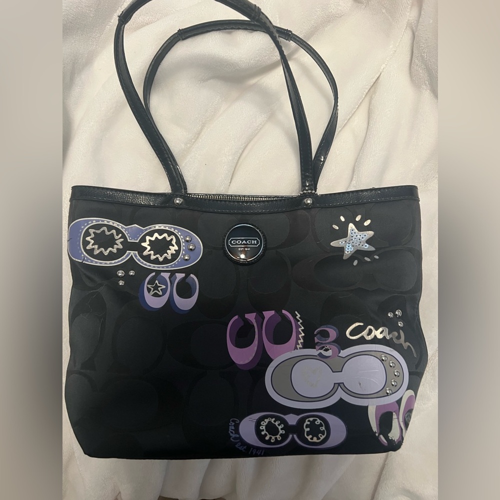 Black coach bag with purple details and sequins